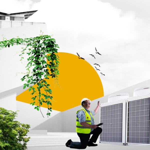 A Mitie engineer looks at a heating fan, with greenery and a yellow sun behind